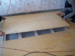 leveling the floor with plywood on the logs 2
